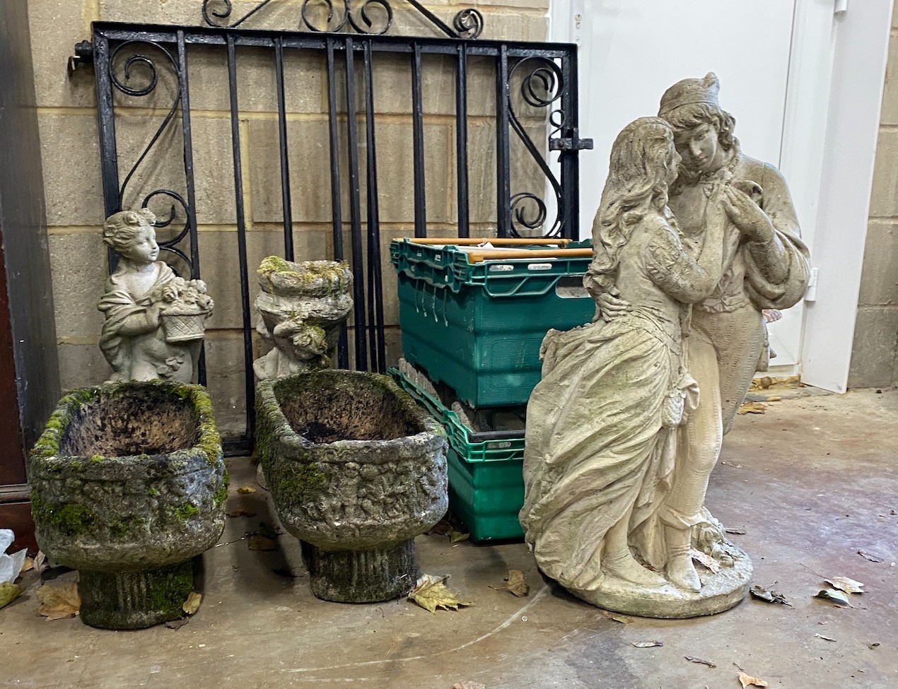 A small pair of rounded rectangular garden planters, a bird bath and two garden figures